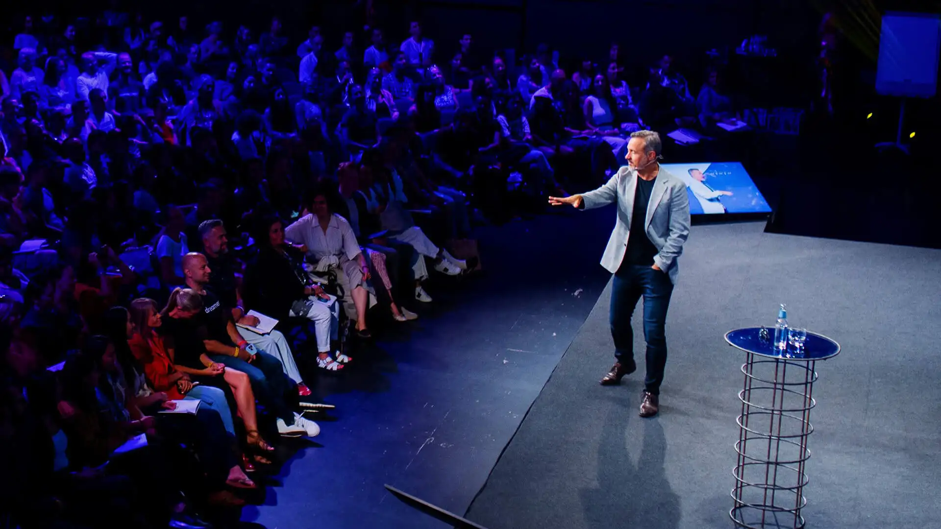 Eric Edmeades on stage with audience